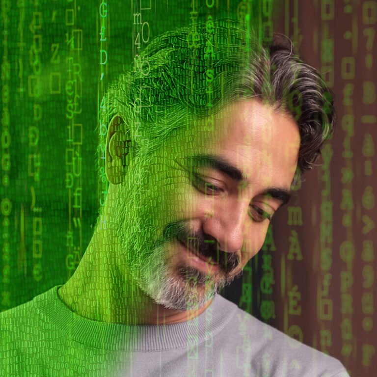 A matrixed version of John Dawson, with letters and numbers crossing the screen, but where we see a part of his face emerging from the matrix.